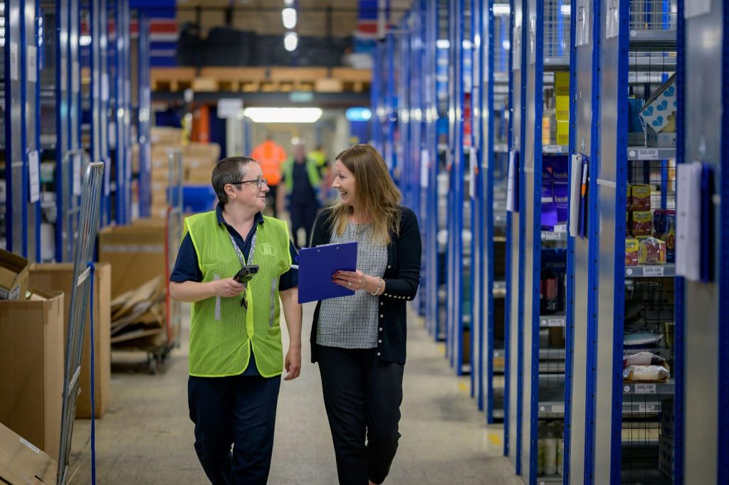 Logistics managers reviewing scheduling and operations in warehouse.